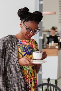 a photo of a woman holding a cup of coffee