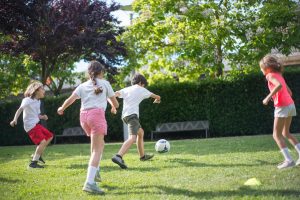 a photo of a group of children playing soccer