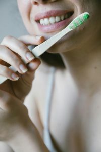 a close up picture of a woman holding a toothbrush