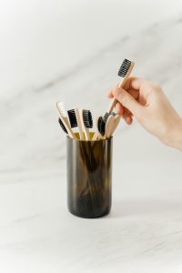 a person taking a toothbrush
